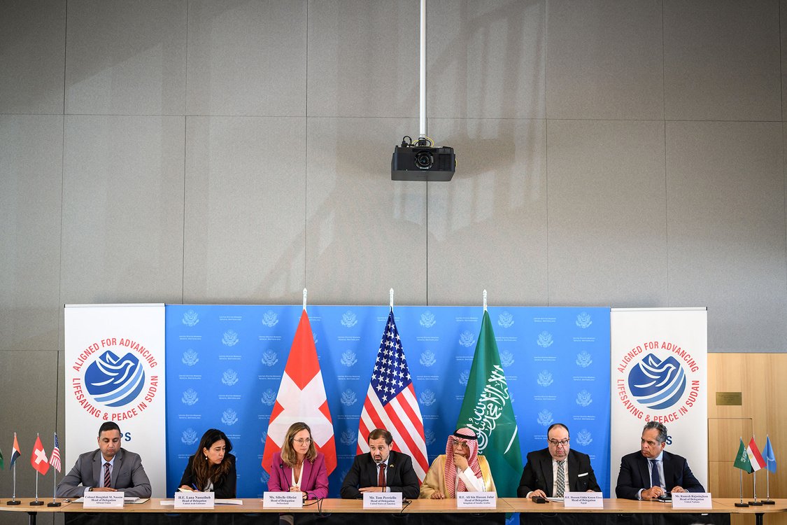 Representatives of  the United States, Egypt, Saudi Arabia, and Switzerland are seen sitting at a negotiating table.