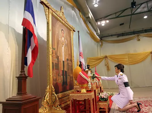 Thailand's PM Yingluck Shinawatra pays respect in front of a portrait of Thai King Bhumibol Adulyadej in Bangkok.