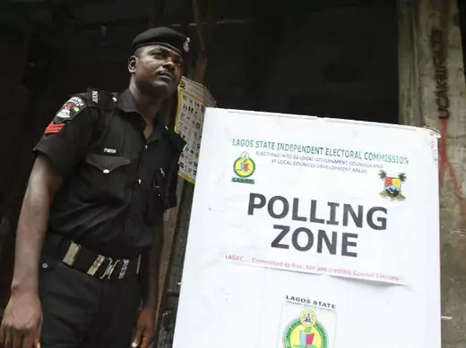 A policeman stands near a polling booth during the local government election in Nigeria's commercial capital Lagos October 22, 2011.