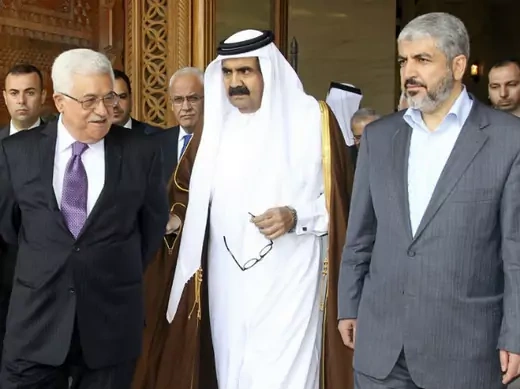 Palestinian president Mahmoud Abbas and Hamas leader Khaled Meshaal walk with Qatar's emir sheikh Hamad bin Khalifa al-Thani as they arrive to sign an agreement in Doha on February 6, 2012 (Courtesy Reuters). 