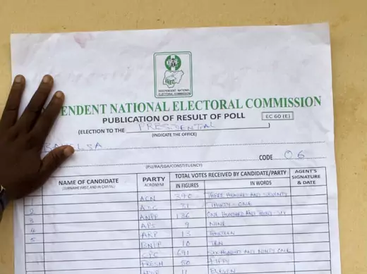 An electoral official pastes local results of presidential elections on the wall of the Yenagoa electoral commission in Bayelsa, April 17, 2011. 