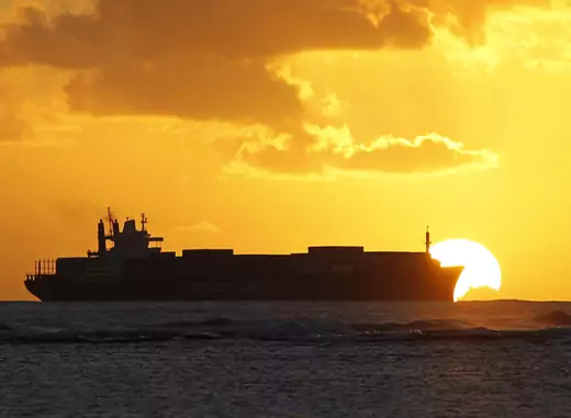 A cargo ship cruises as the sun sets at Ala Moana beach ahead of the APEC meeting in Honolulu