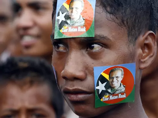 A youth pastes stickers of Timor-Leste's presidential candidate and former military commander Taur Matan Ruak on his face during a campaign rally in Dili March 10, 2012.
