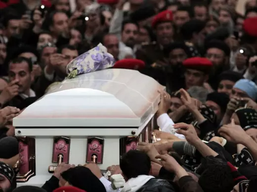 Egyptian Coptic priests and Christians carry the coffin of Pope Shenouda III, the head of Egypt's Coptic Orthodox Church, upon its arrival for burial at St. Bishoy Monastery in Wadi al-Natrun, on March 20, 2012 (Mohamed Abd El Ghany/Courtesy Reuters). 