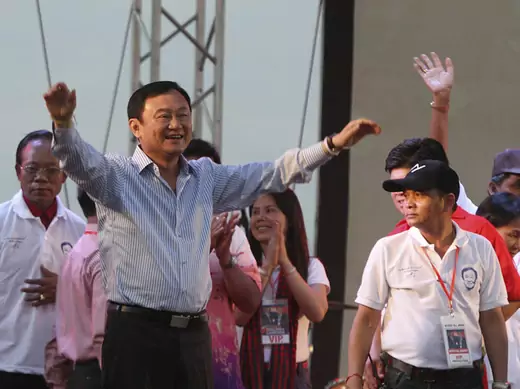 Former Thai prime minister, Thaksin Shinawatra (front L), welcomes his supporters during a ceremony in Siem Reap province, Cambodia, April 14, 2012. 