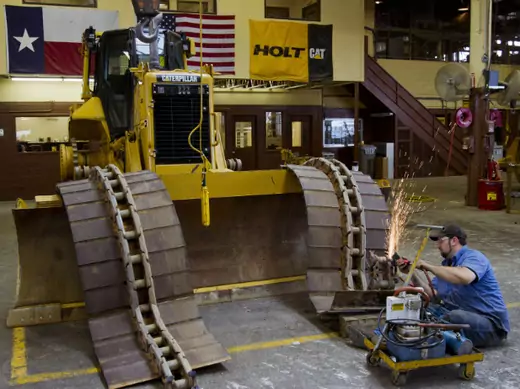 A worker assembles tracks on a Caterpillar bulldozer at a Texan equipment dealer; the Peoria, Ill.-based manufacturer is expected to be a large beneficiary of improved trade opportunities with Colombia. (Richard Carson/Courtesy Reuters)