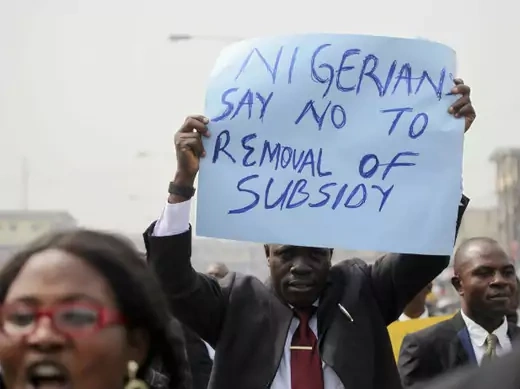A member of the Nigerian Bar Association holds up a placard to protest a fuel subsidy removal in Lagos January 5, 2012.