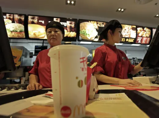 Employees at a McDonald's Restaurant in Beijing serve food to customers in October 2011 (Stringer/Courtesy Reuters). 