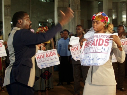 HIV/AIDS patient Miss Mary Udoh receives "miraculous healing" from Prophet T.B. Joshua of the synagogue Church For All Nations during a service at Ikotun-Egbe district in Lagos, the commercial nerve centre of Nigeria, in this January 20, 2003 file photo.