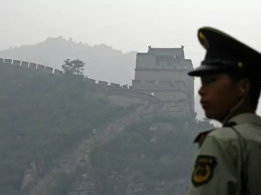 A policeman stands near the Great Wall on a hazy day in Juyongguan, China. 