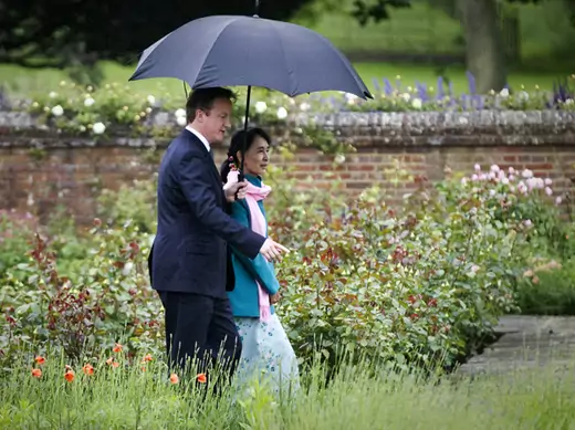 Britain's Prime Minister David Cameron and Myanmar pro-democracy leader Aung San Suu Kyi walk in the rose garden at Chequers, the Prime Minister's official country residence in Buckinghamshire, southern England June 22, 2012.   