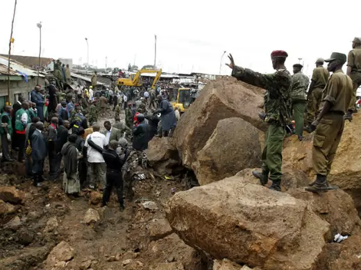 Policemen secure the scene of a landslide at the Mathare valley slum after boulders, rocks and mud tumbled down a hillside overlooking the slum, smashing into the houses and burying the occupants in Kenya's capital Nairobi, April 4, 2012. 
