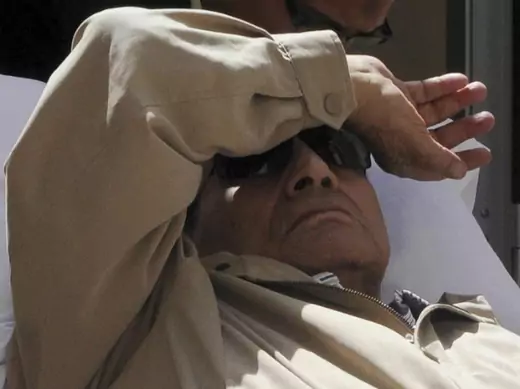 Former Egyptian President Hosni Mubarak is wheeled out of the courtroom in Cairo