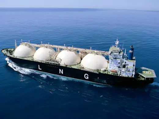 An Australian liquified natural gas (LNG) carrier, with four cyrogenic storage tanks that hold LNG, sails off the coast of Western Australia (Handout/Courtesy Reuters). 
