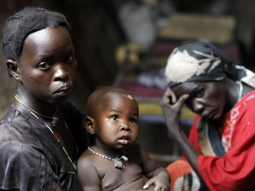 A woman holds her child in a cave in Bram village in the Nuba Mountains, South Kordofan, April 28, 2012.