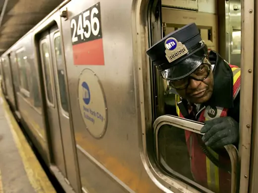 A New York subway conductor checks the train doors before departing Columbus Circle station in December 2005 (Courtesy Reuters). 