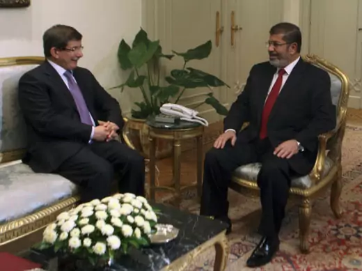 Egypt's President Mohamed Mursi attends a meeting with Turkish Foreign Minister Davotoglu at the presidential palace in Cairo