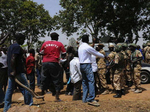 Security forces confront angry citizens at a roadblock after a bombing at St. Finbarr's Catholic Church in the Rayfield suburb of the Nigerian city of Jos March 11, 2012.