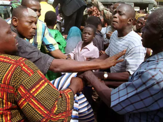 Displaced Lagos residents fight over blankets which were handed out as aid, January 29, 2002, after explosions at an armoury on Sunday.