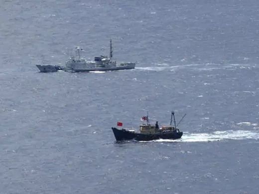A Japan Coast Guard patrol ship sails around a Hong Kong fishing boat near the disputed islands in the East China Sea, known as Senkaku in Japan or Diaoyu in China