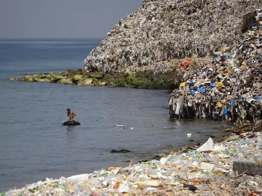 A fisherman is seen near a rubbish dump on the Sidon seafront in south Lebanon