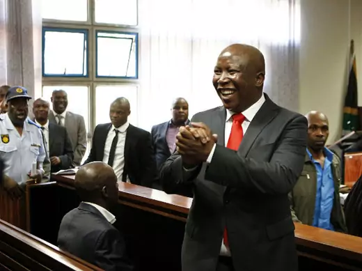 South African former ANC Youth League leader Julius Malema gestures to his supporters during his court appearance in Polokwane 26/09/2012.