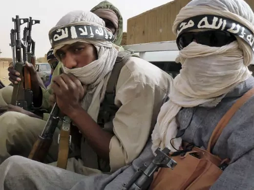 Militiaman from the Ansar Dine Islamic group, who said they had come from Niger and Mauritania, ride on a vehicle at Kidal in northeastern Mali, June 16, 2012.