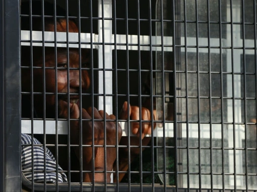 A detained miner peers out of a police van as it arrives at court in Ga Rankuwa, near Pretoria 03/09/2012