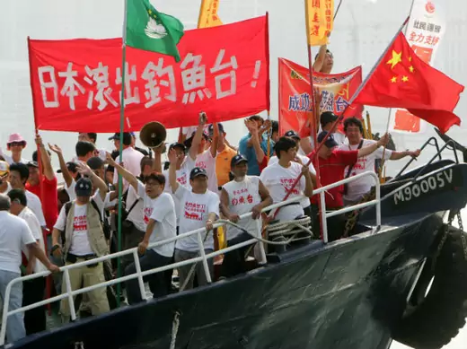 Activists from the Action Committee for Defending the Diaoyu Islands shout slogans and wave the Chinese flag in Hong Kong 