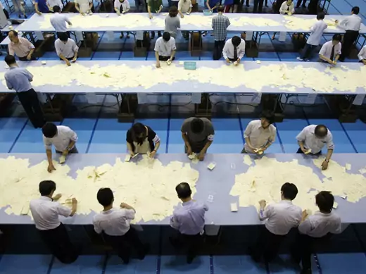 Election officers count votes at a ballot counting center for the upper house election in Tokyo
