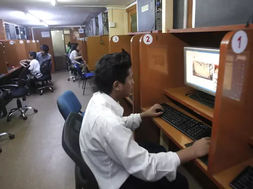 A man looks at YouTube at an Internet cafe in Yangon, Myanmar.