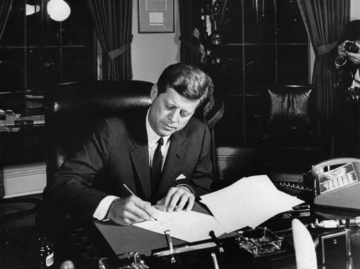 President John F. Kennedy signs Proclamation 3504 authorizing the quarantine of Cuba on October 23, 1962. (Abbie Rowe. White House Photographs. John F. Kennedy Presidential Library and Museum, Boston)