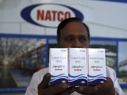 An official poses with packets of Sorafenib Tosylate tablets inside the head office of Natco in Hyderabad