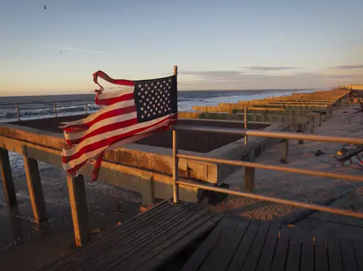 An American flag stands on top of the devastated Rockaway beach boardwalk in Queens after Hurricane Sandy (Shannon Stapleton/ Courtesy Reuters).