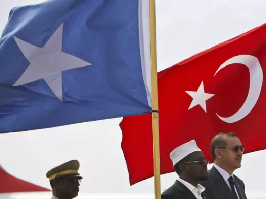 Turkey's PM Erdogan and Somalia's President Ahmed stand in front of their countries' national flags as they listen to the national anthems in Mogadishu 19/08/2011.