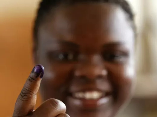 Woman with shows off her inked finger after casting her vote during the national elections in the capital Luanda, Angola 31/08/2012.