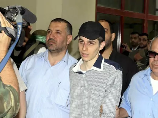 Ahmed Al-Jaabari, chief of the armed wing of Hamas, escorting Israeli soldier Gilad Shalit on the Egyptian side of the Rafah border crossing on October 18, 2011 (Farid/Courtesy Reuters).