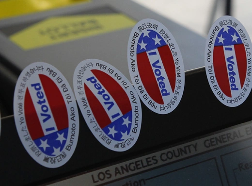 Stickers stating "I Voted" in several languages are affixed to a ballot intake machine during the 2012 national election (Fred Prouser/Courtesy Reuters).