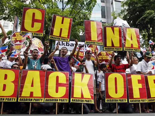 Filipino protesters shout anti-China slogans while holding placards during a demonstration outside the Chinese consulate in Manila