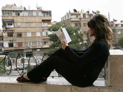 Syrian Bedouin writer and journalist Lina Hawyan al-Hassan, reads a book at her home in Damascus (Khaled Al Hariri / Courtesy Reuters)
