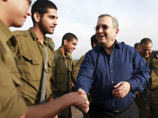 Israel's defence minister Barak shakes hands with a soldier during a news conference near Tel Aviv on November 18, 2012 (Bar-On/Courtesy Reuters).