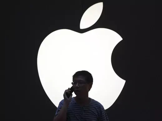 A man talks on a mobile phone in front of an Apple logo outside an Apple store in downtown Shanghai on September 3, 2012 (Aly Song/Courtesy Reuters).