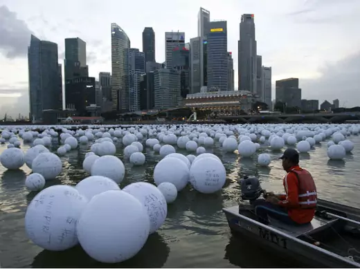 A boatman arranges wishing spheres released onto the Singapore River as part of New Year Day celebrations. (Edgar Su/Courtesy Reuters)