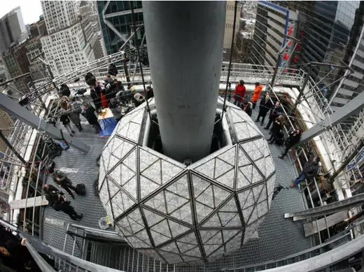 Journalists watch workers install some of the 288 Waterford crystals on the Times Square New Year's Eve Ball in New York (Mike Segar/Courtesy Reuters).
