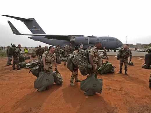 French soldiers carry their equipment after arriving in Bamako, Mali on a U.S. transport plane (Eric Gaillard/Courtesy Reuters). 