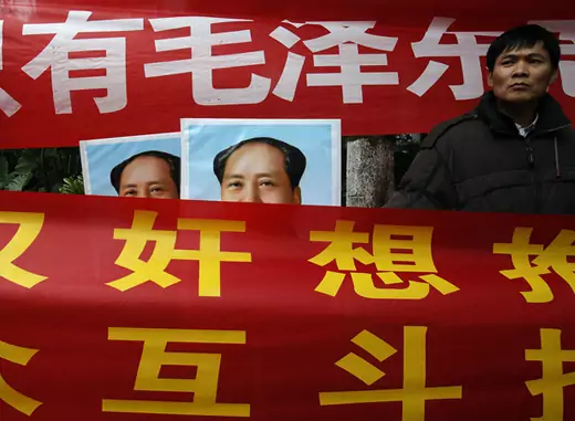 Leftists displaying banners and portraits of the late Chinese leader Mao Zedong demonstrate outside the office of the liberal Southern Weekly newspaper in the southern Chinese city of Guangzhou January 9, 2013, denouncing the newspaper as "a traitor newspaper" for defying the party.