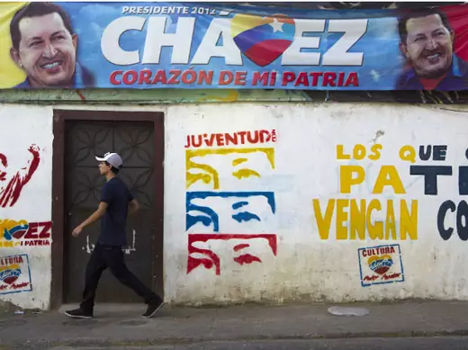 A man walks past a mural depicting Venezuelan President Hugo Chavez in Caracas (Carlos Garcia Rawlins/Courtesy Reuters).