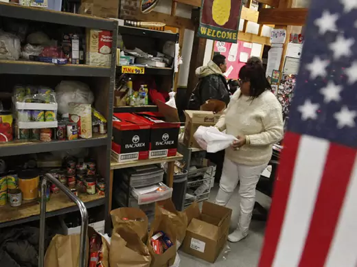 A coordinator at Bread for the City food pantry in Washington, DC fills up a bag of food to distribute (Jim Young/Courtesy Reuters).