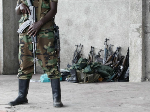M23:  A M23 rebel guards weapons returned by the government's army in Goma city November 21, 2012. 