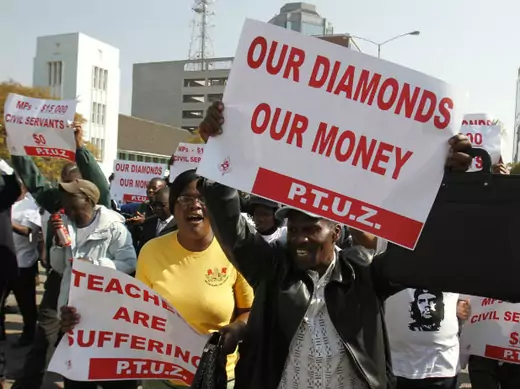 Zimbabwe's civil servants sing and dance during their march to the Finance Minister's office and the Parliament for their salary raise in Harare, July 24, 2012.